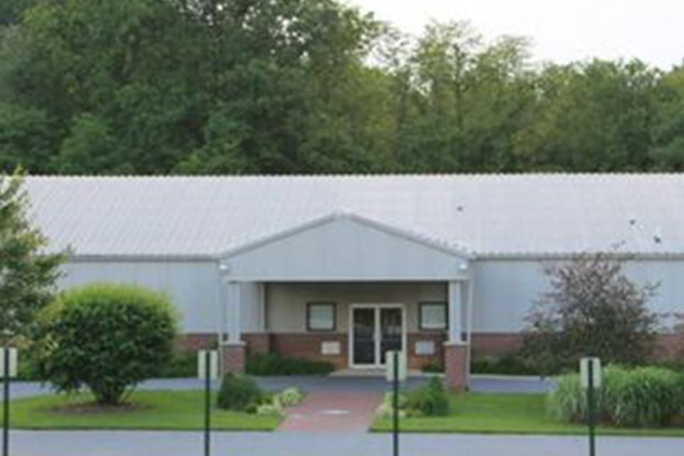 A white building with a front porch. A white building with a front porch.
